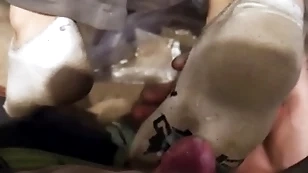 Three young guys insulting socks footjob
